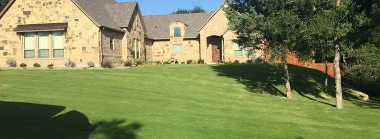 North Texas brick home with a treated lawn