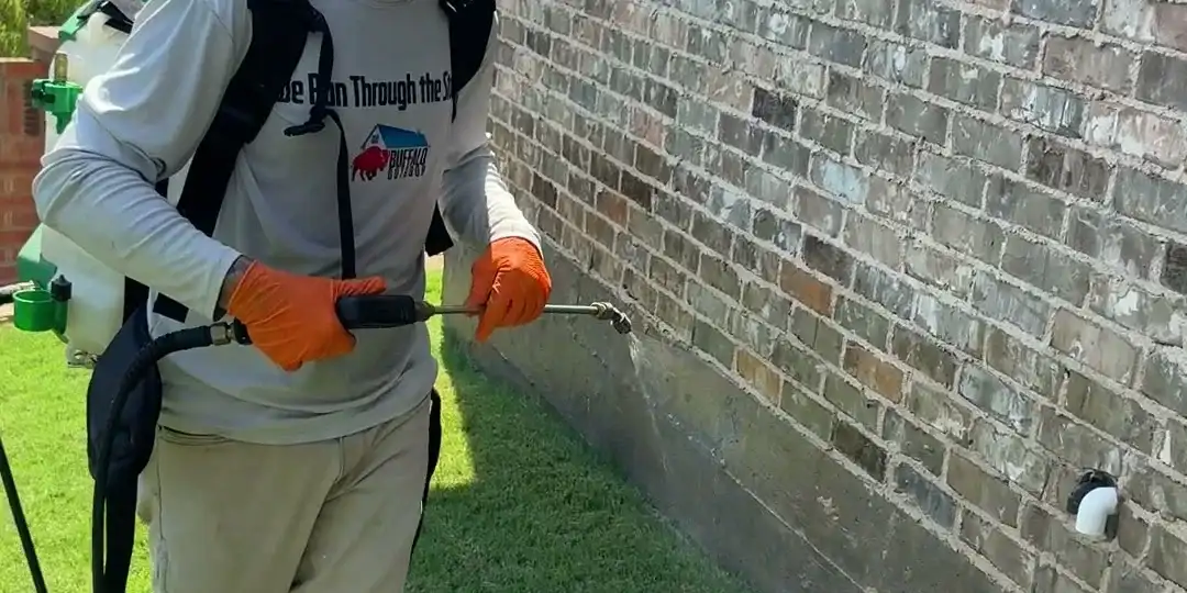 Buffalo Outdoor technician running the perimeter barrier along a home foundation